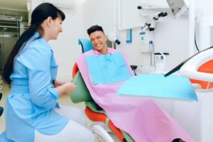 dental assistant with smiling patient