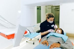 dental assistant examining patient